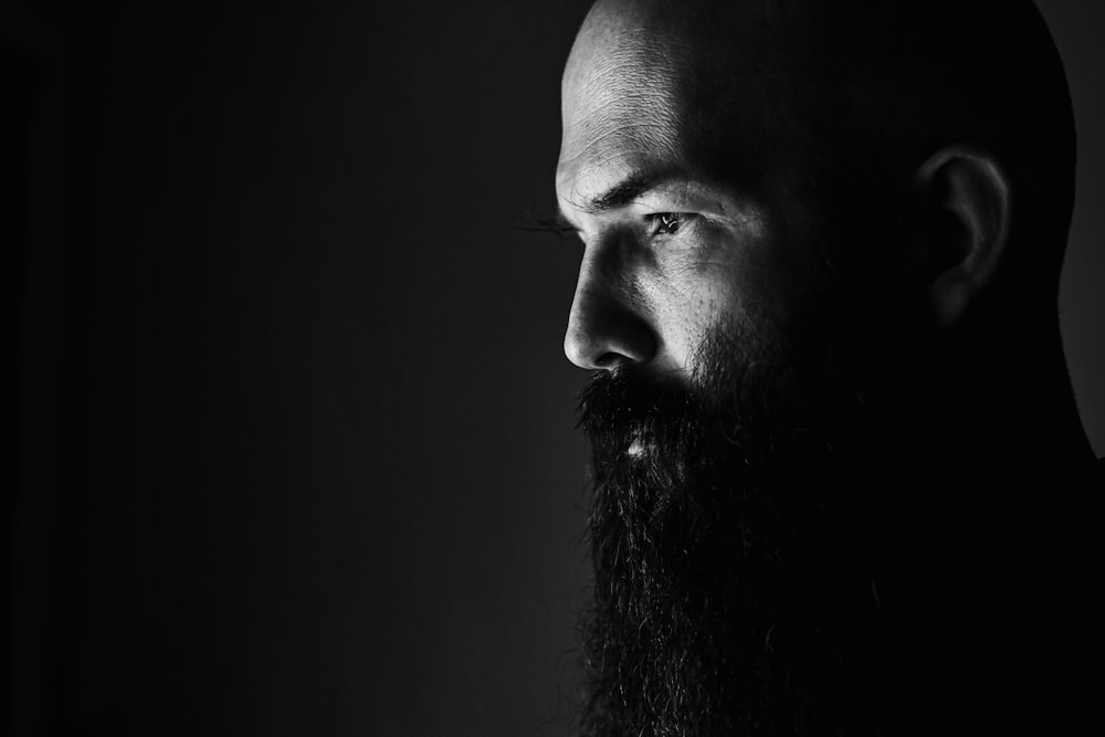 a black and white photo of a man with a beard