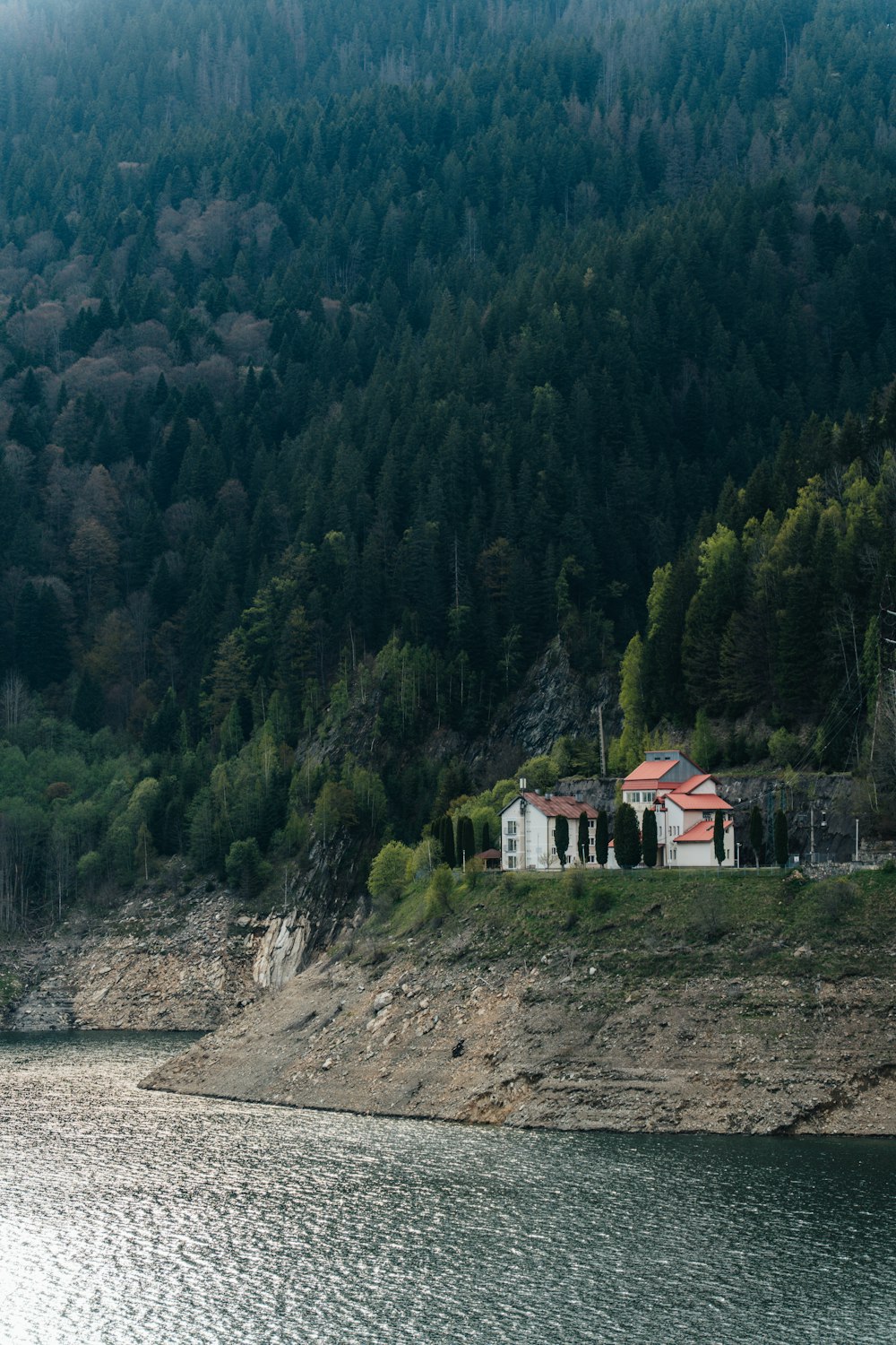 a house sitting on the shore of a lake