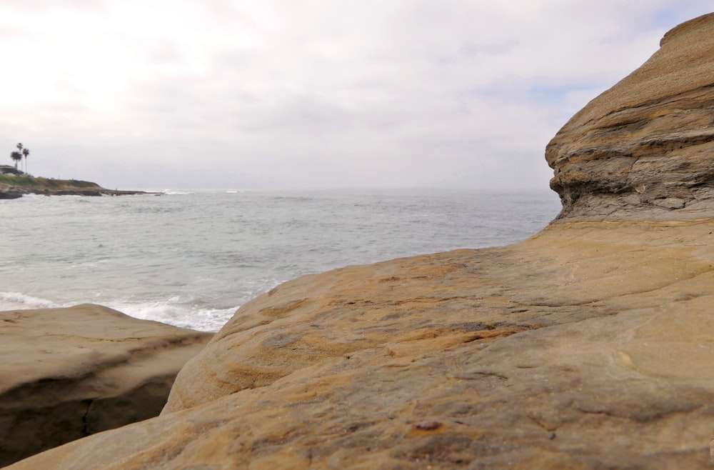 a view of the ocean from a rocky shore