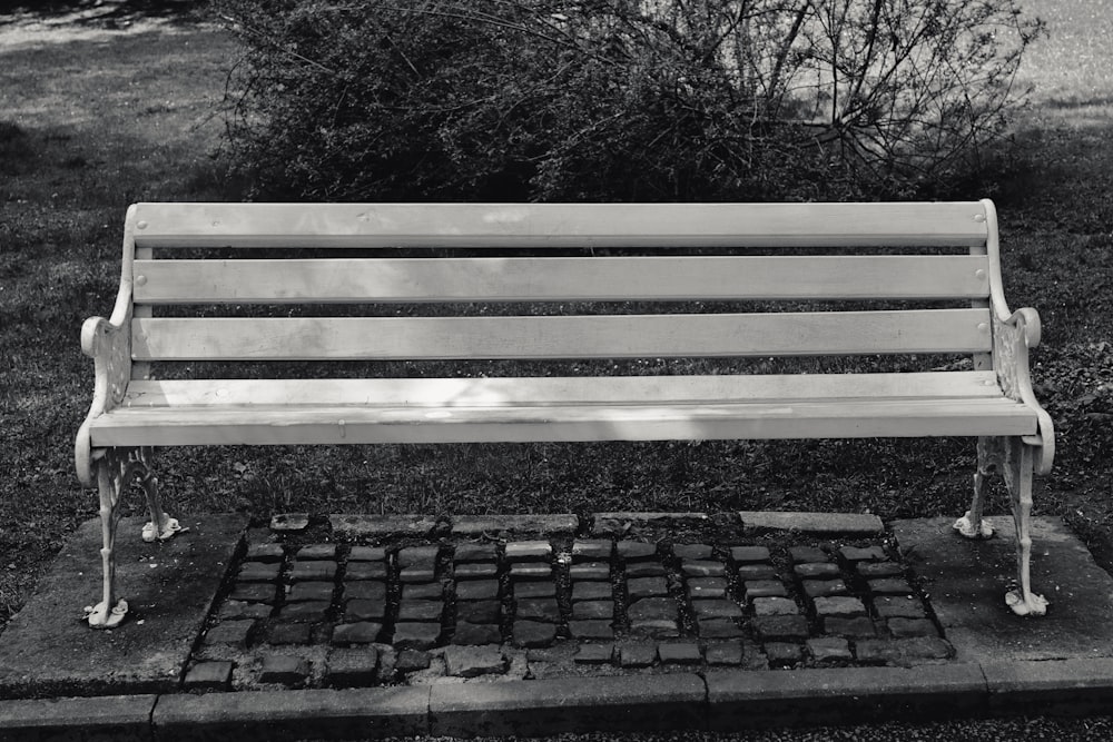 a park bench sitting on top of a cement slab