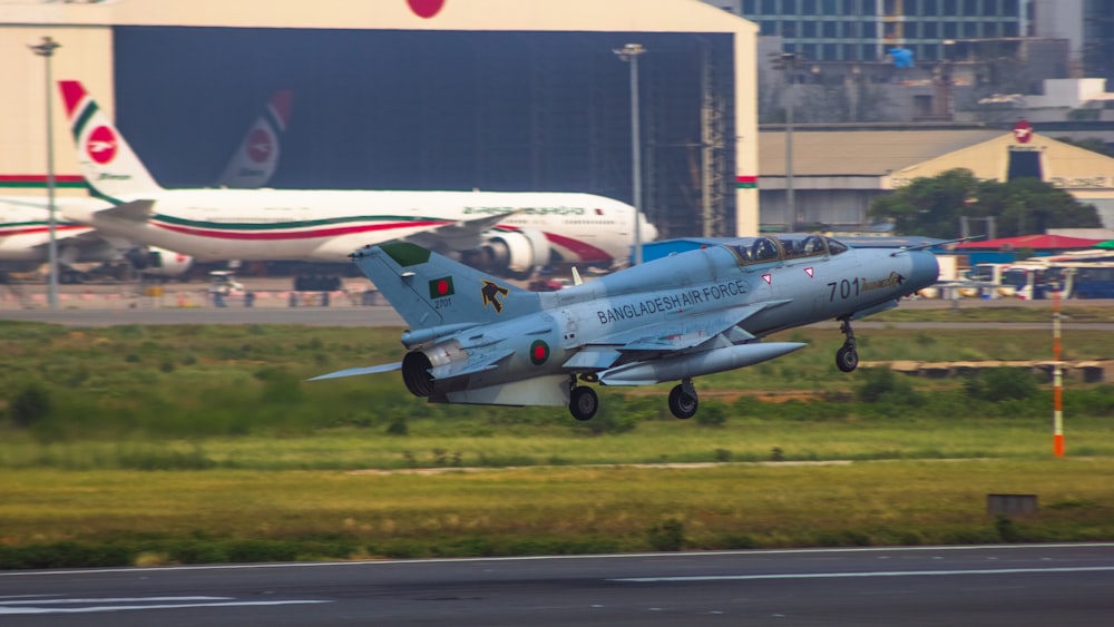 a fighter jet taking off from an airport runway