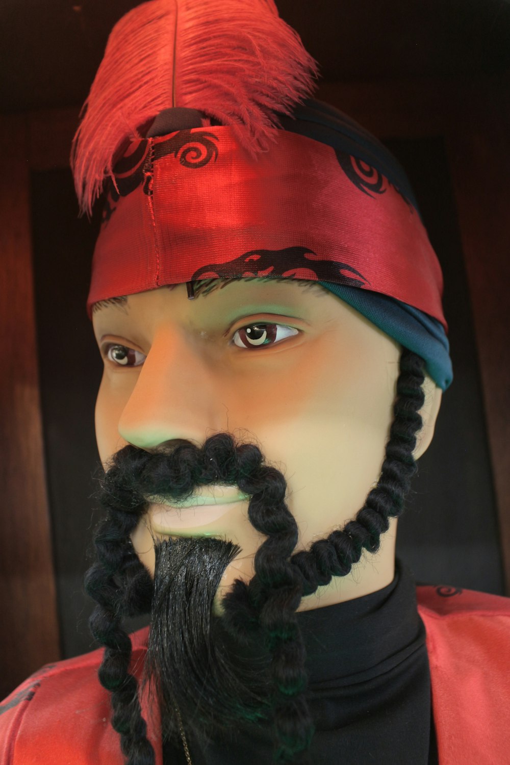 a close up of a mannequin wearing a red hat