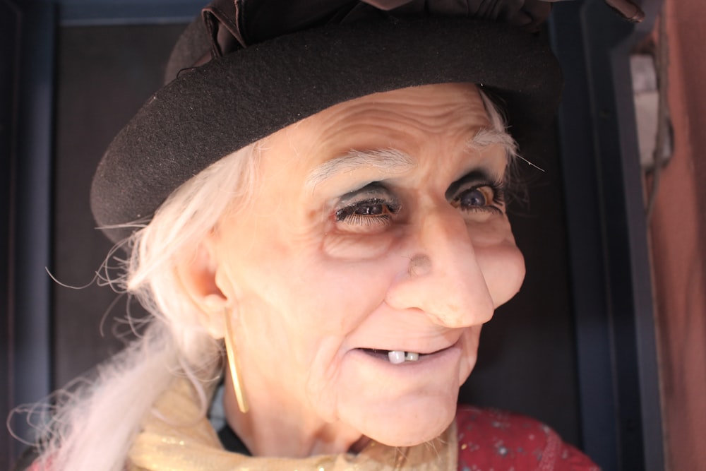 an old woman wearing a hat and a scarf