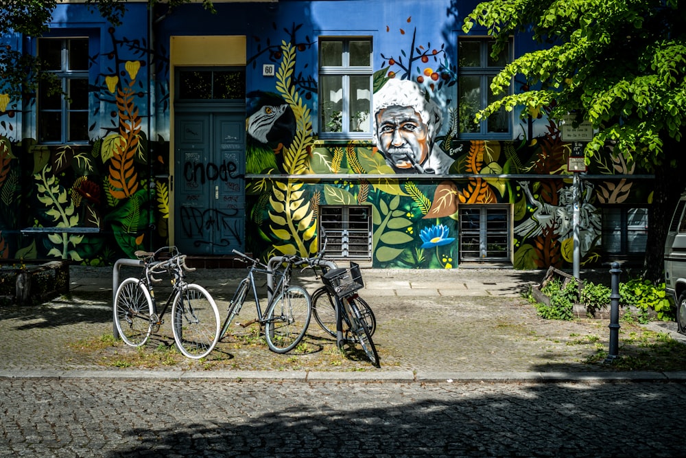 two bicycles parked in front of a colorful building