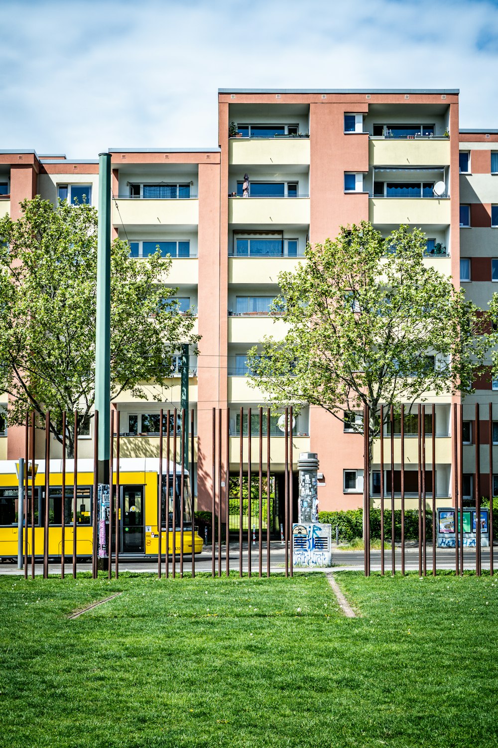 a yellow bus is parked in front of a building