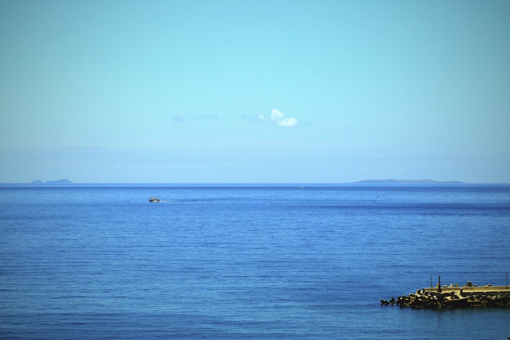 a body of water with a boat in the distance