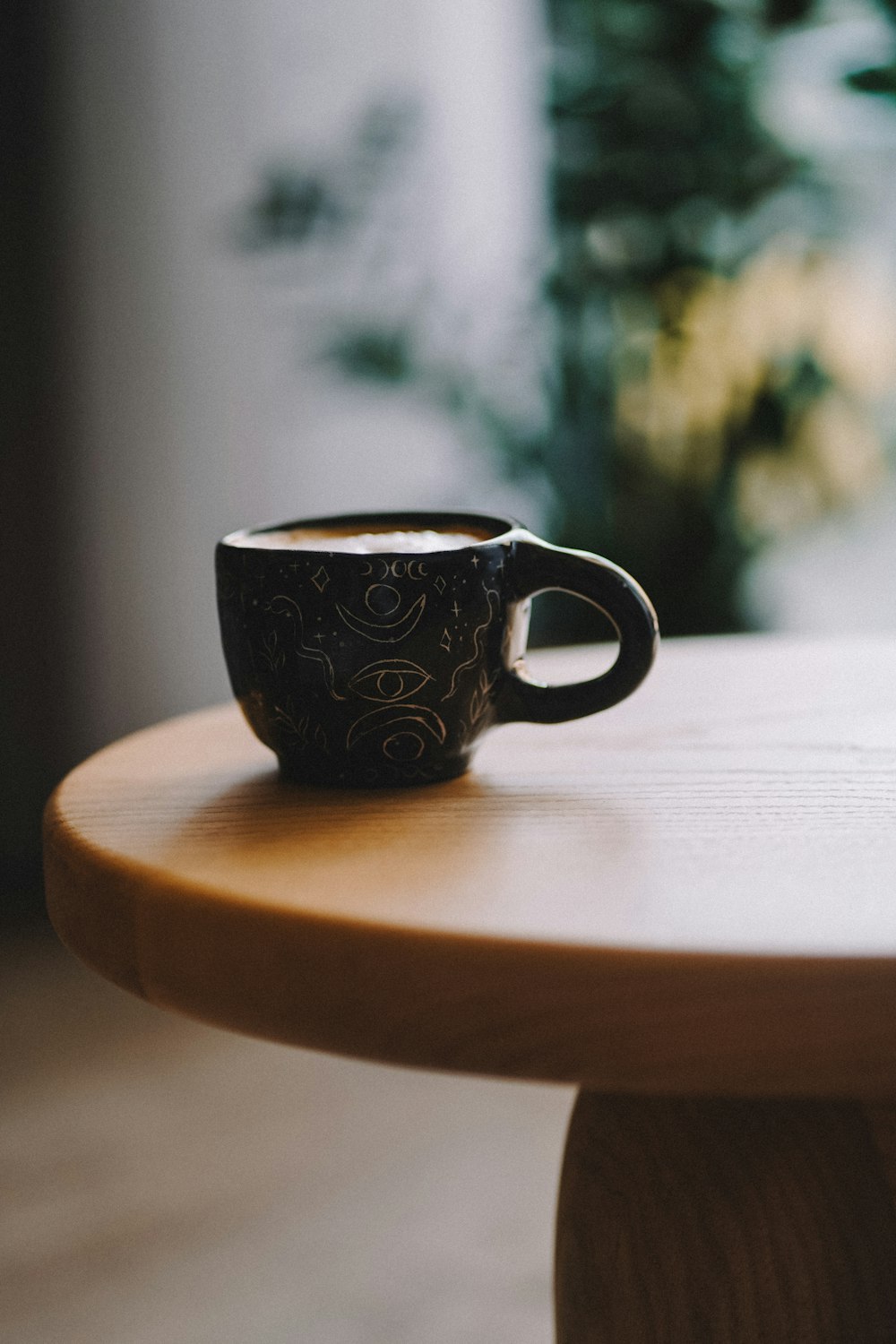 a coffee cup sitting on top of a wooden table