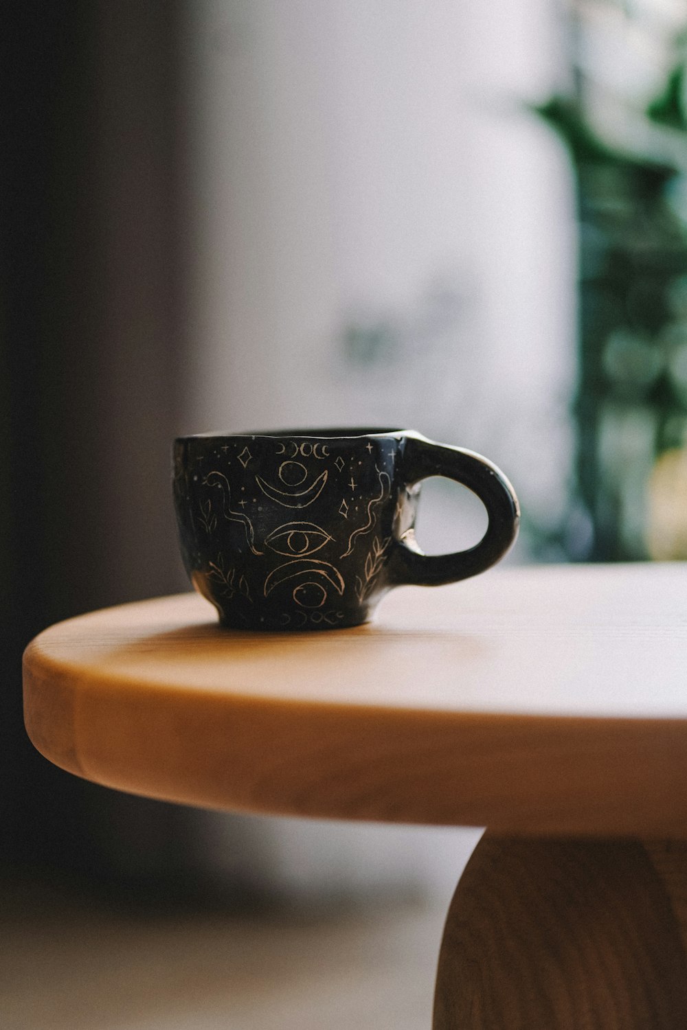 a coffee cup sitting on top of a wooden table