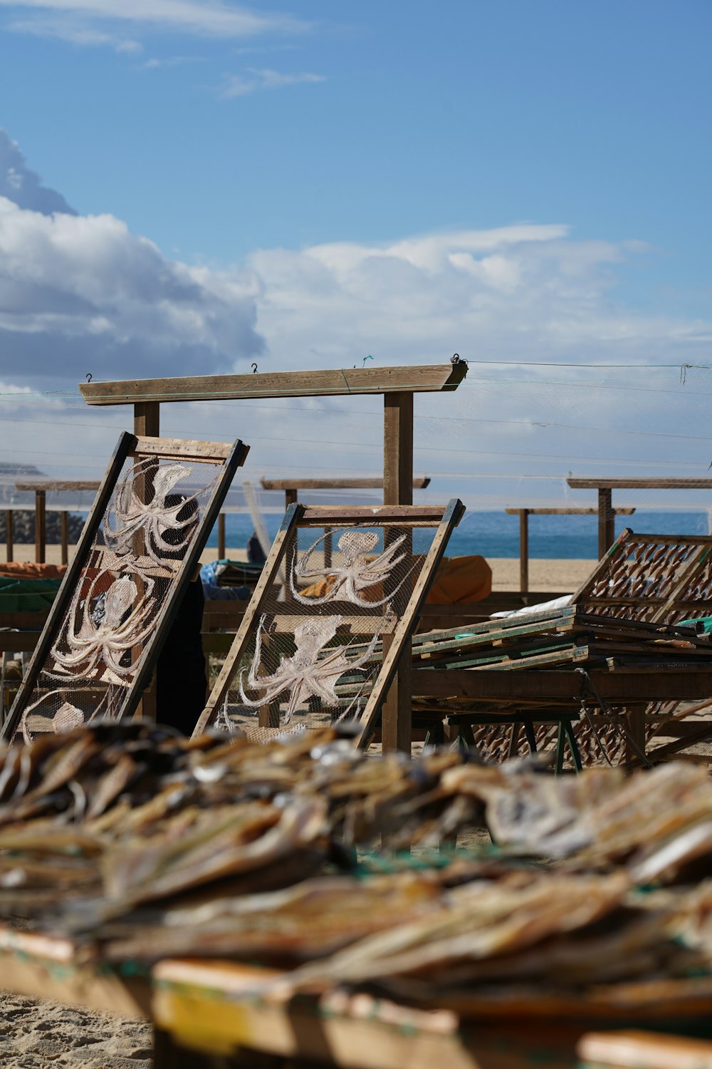 a bunch of chairs sitting on top of a sandy beach