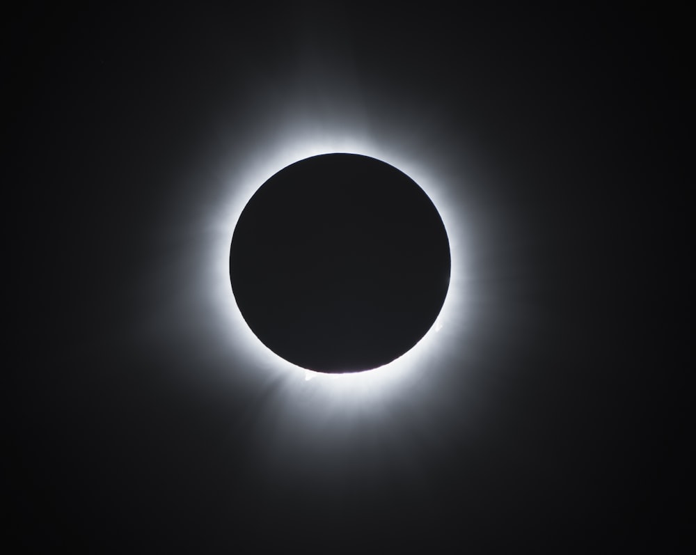 a solar eclipse is seen in the dark sky