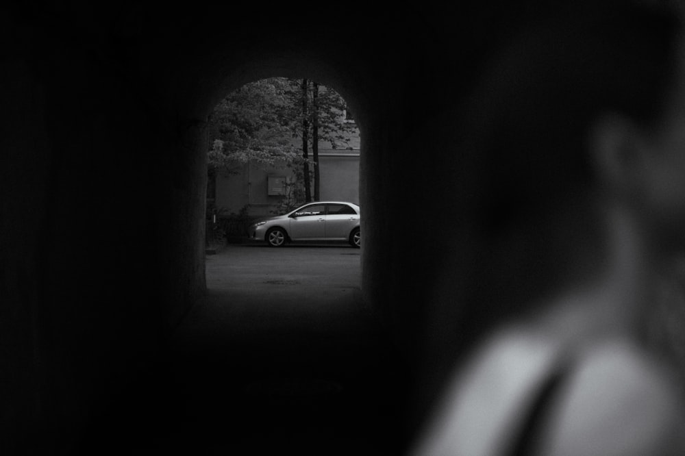 a car is parked in a dark tunnel