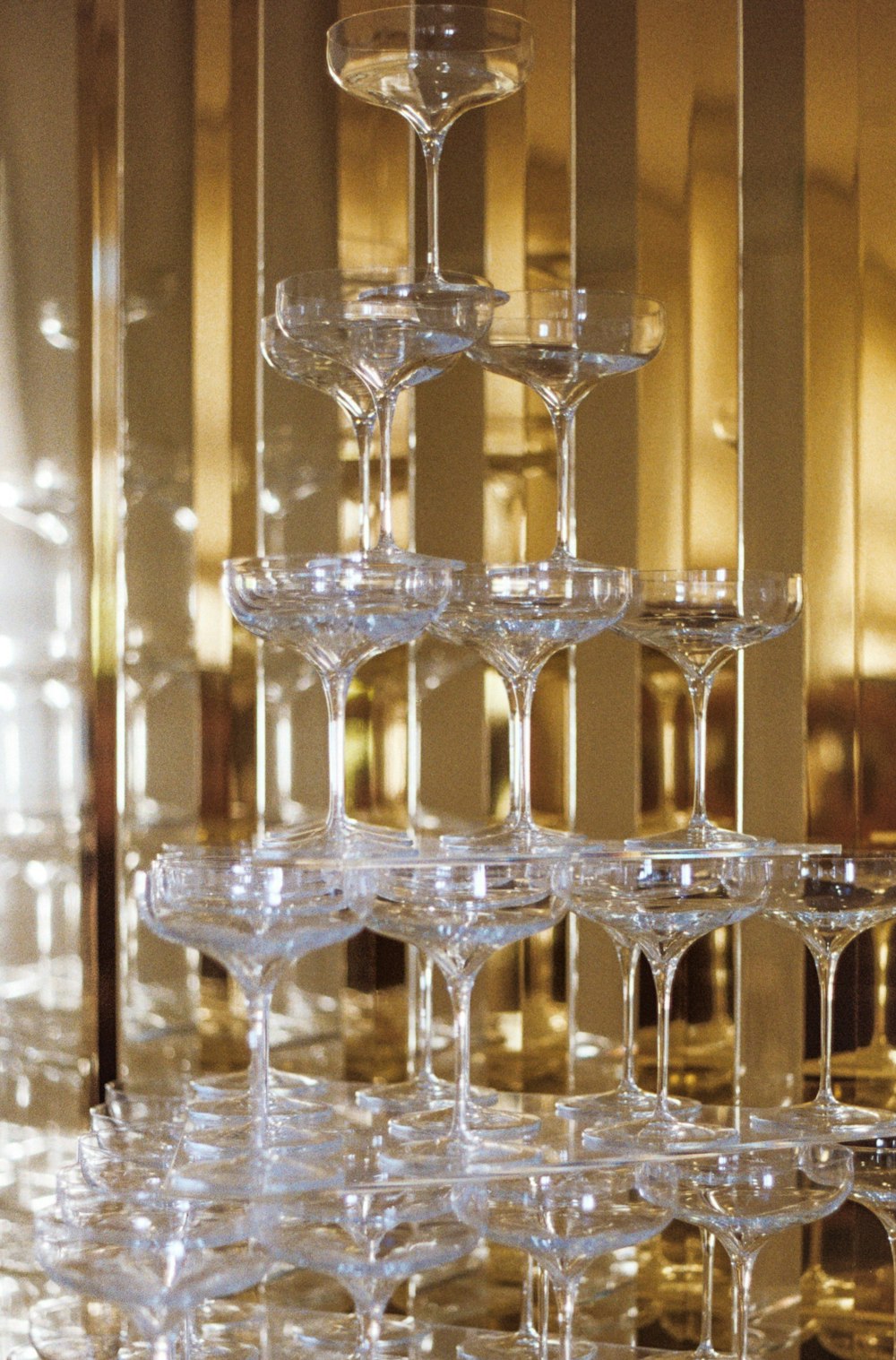 a stack of wine glasses sitting on top of a table