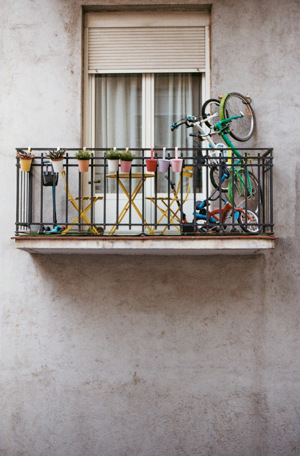 a balcony with several bicycles parked on it