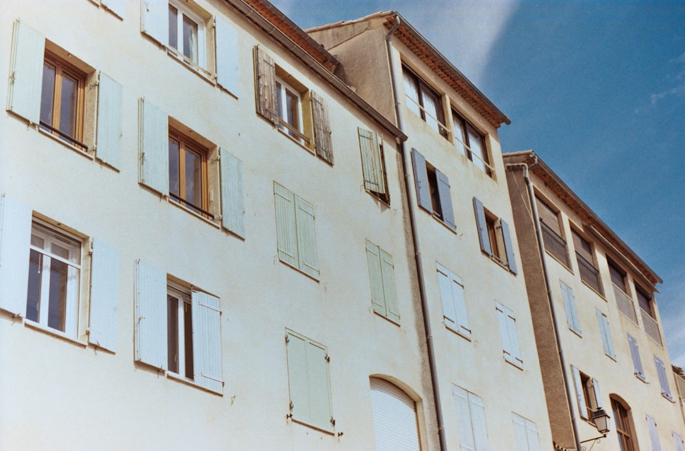 a tall building with lots of windows and shutters