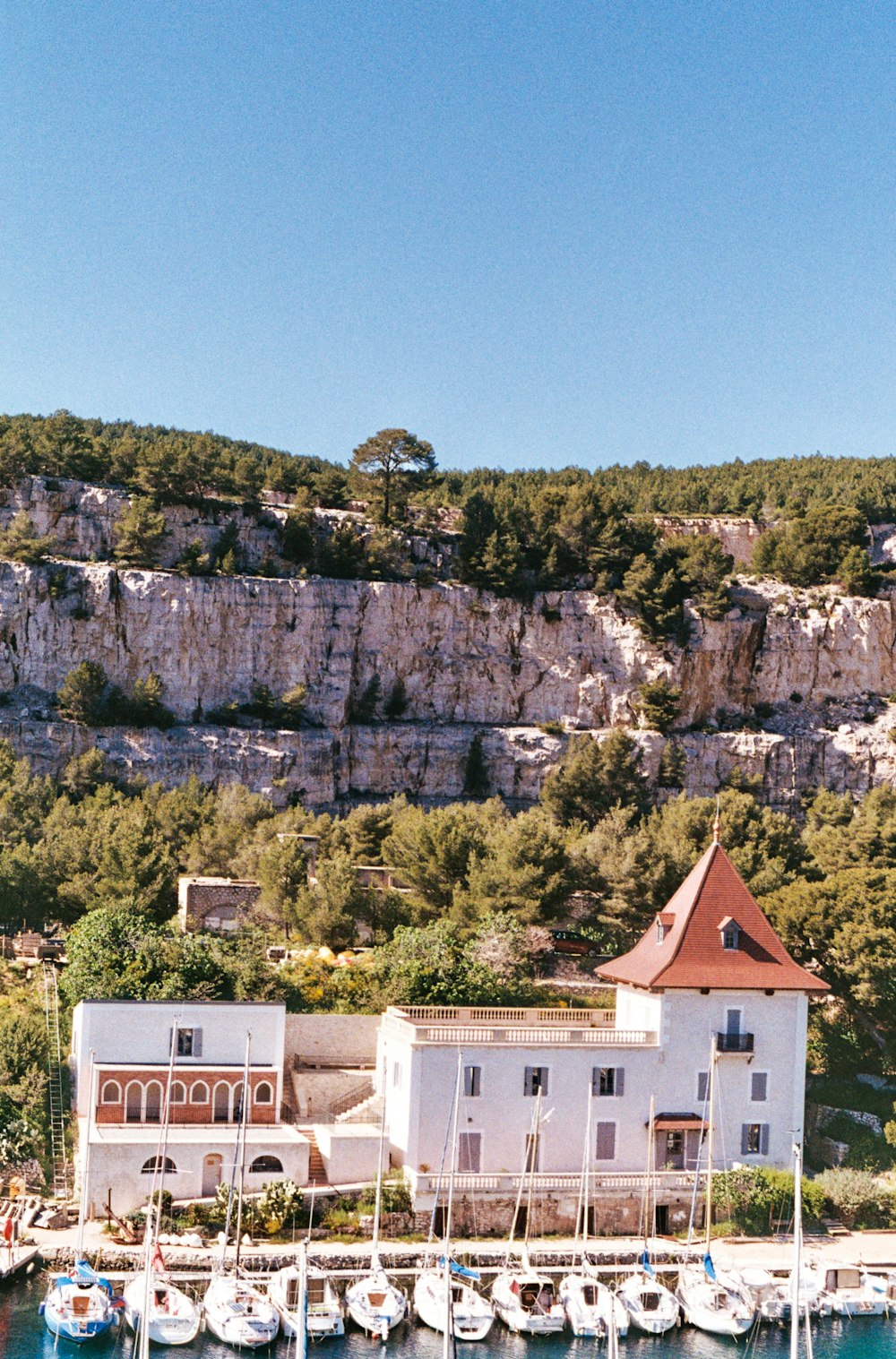 a group of boats parked in front of a white building