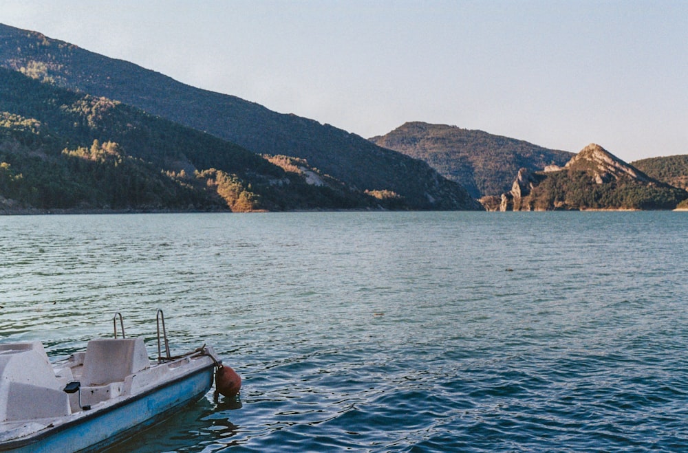 a small boat floating on top of a large body of water