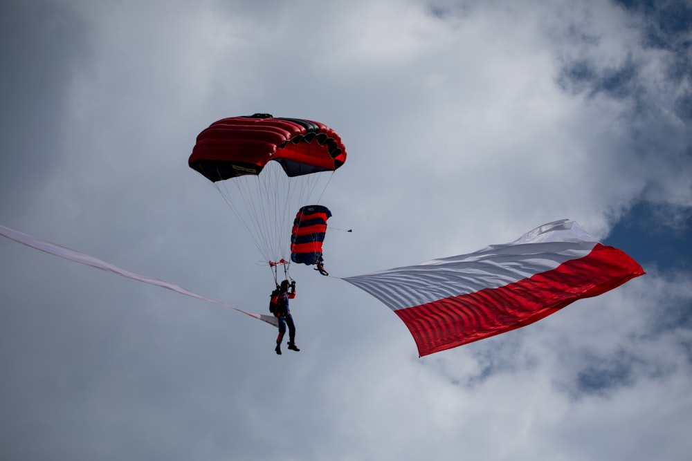 two people are parasailing in the sky