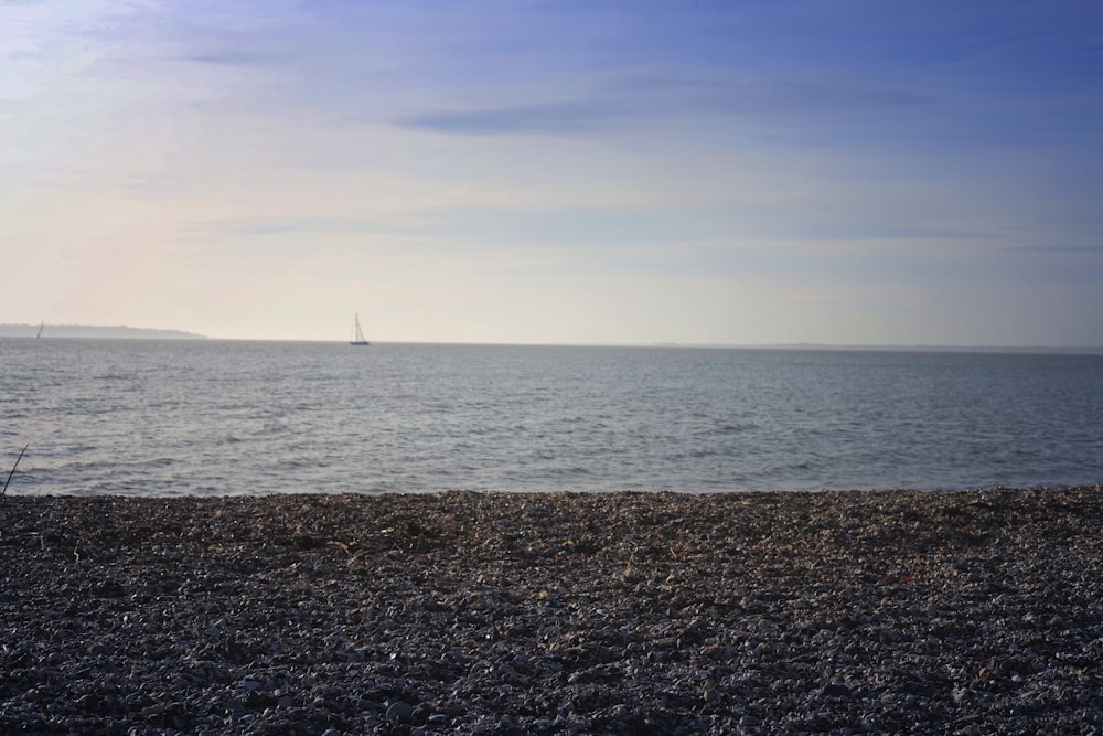 a body of water with a boat in the distance