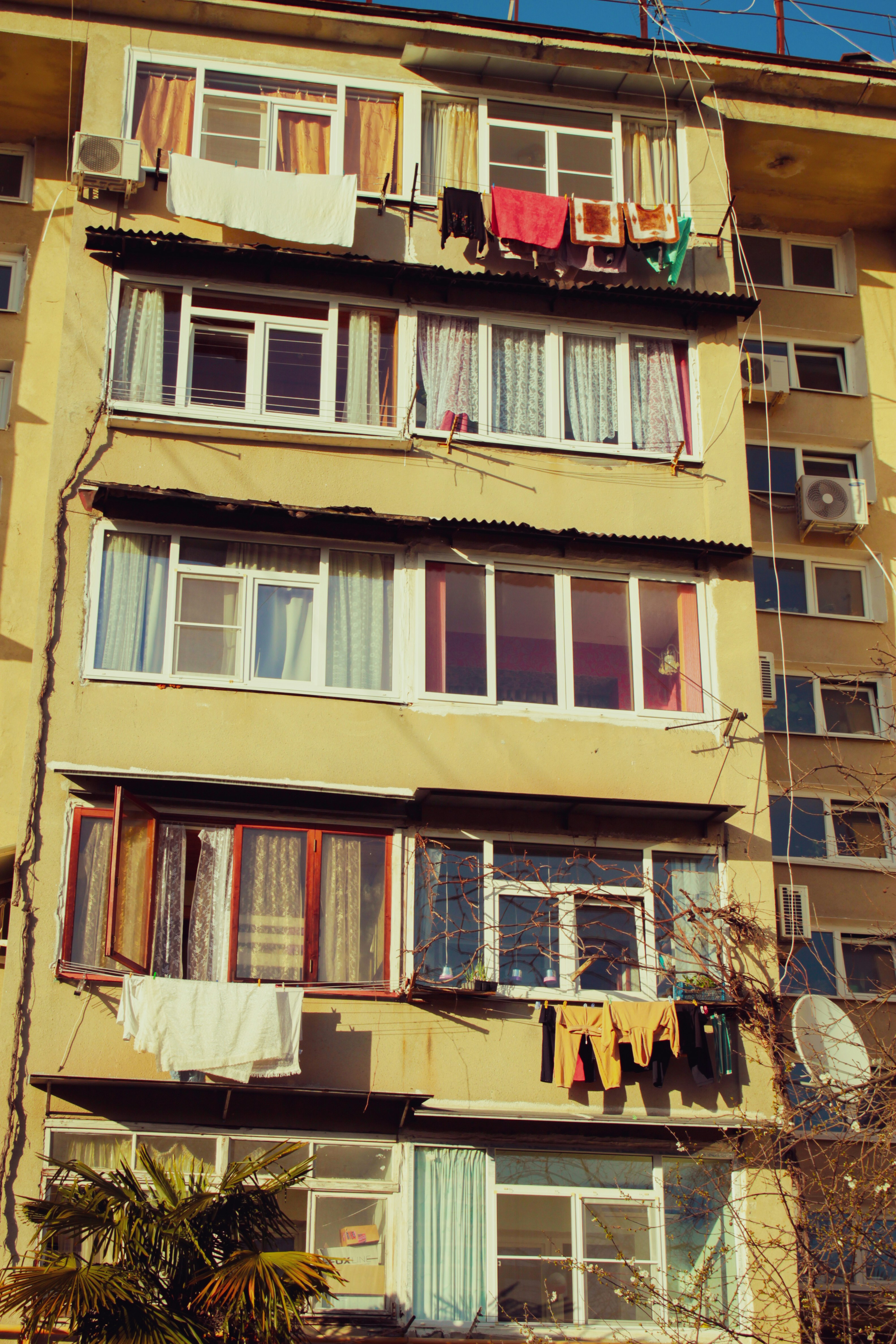 an apartment building with clothes hanging out of the windows