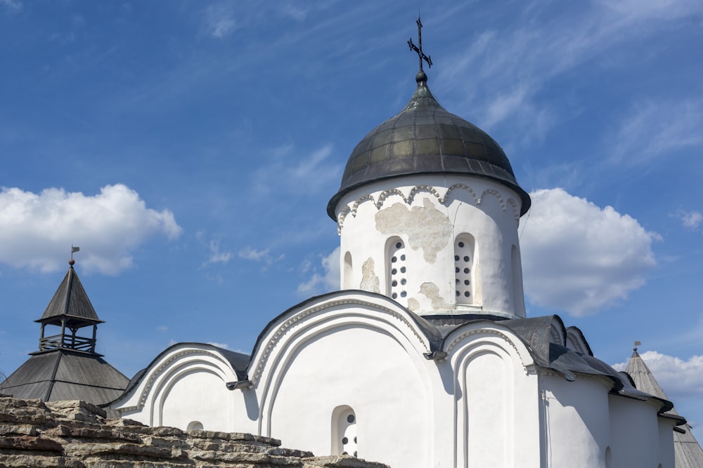 a large white building with a black roof