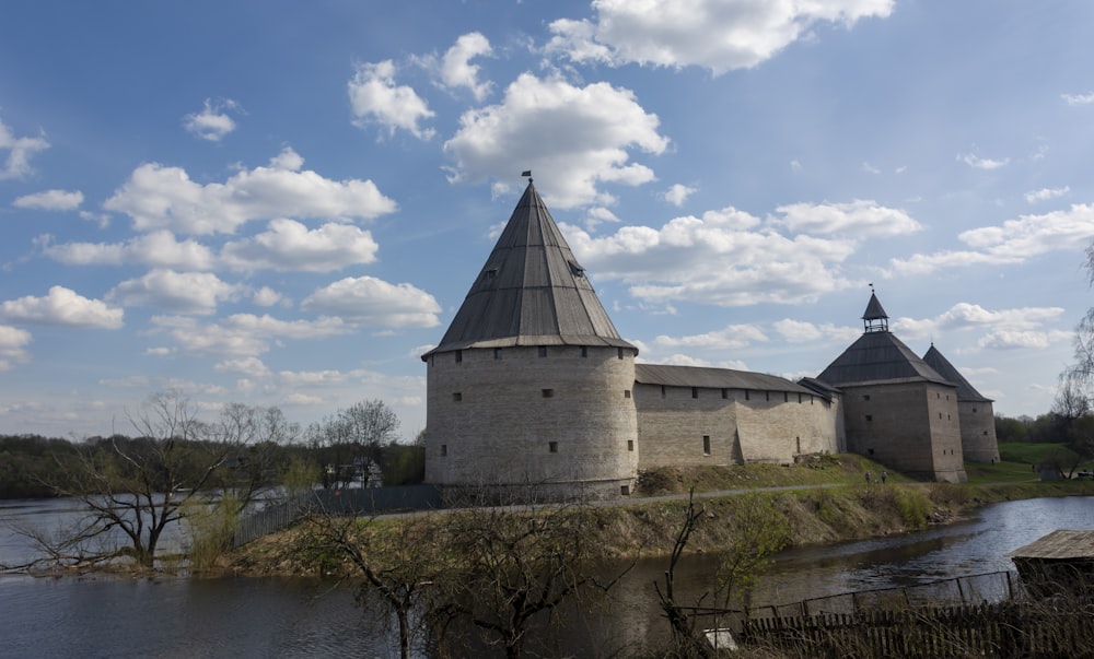 a castle with two towers sitting on top of a river