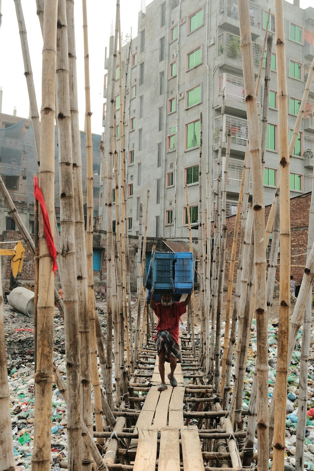 a person walking across a wooden bridge over a river