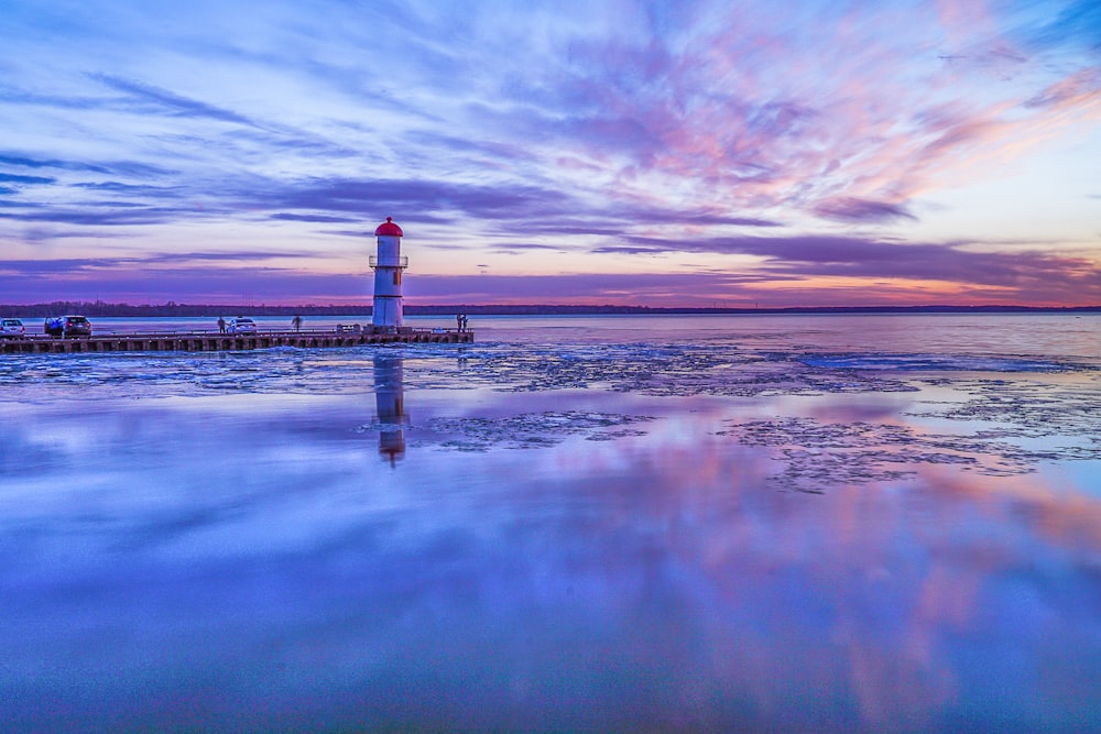 a light house sitting on top of a body of water