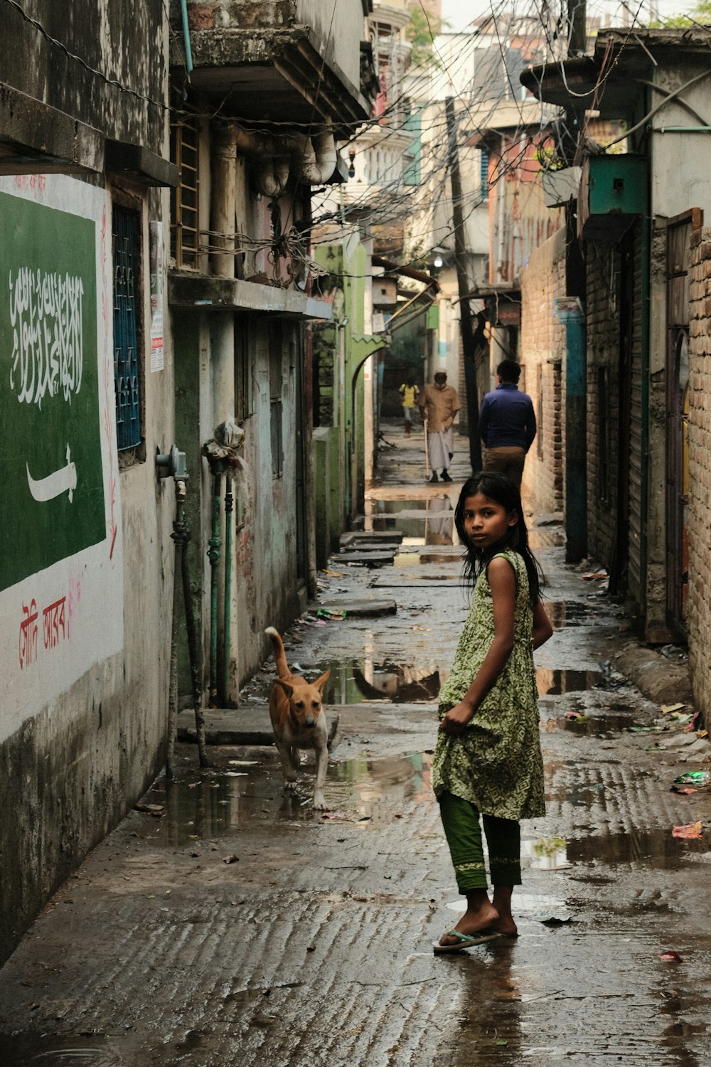 a little girl that is standing in the rain