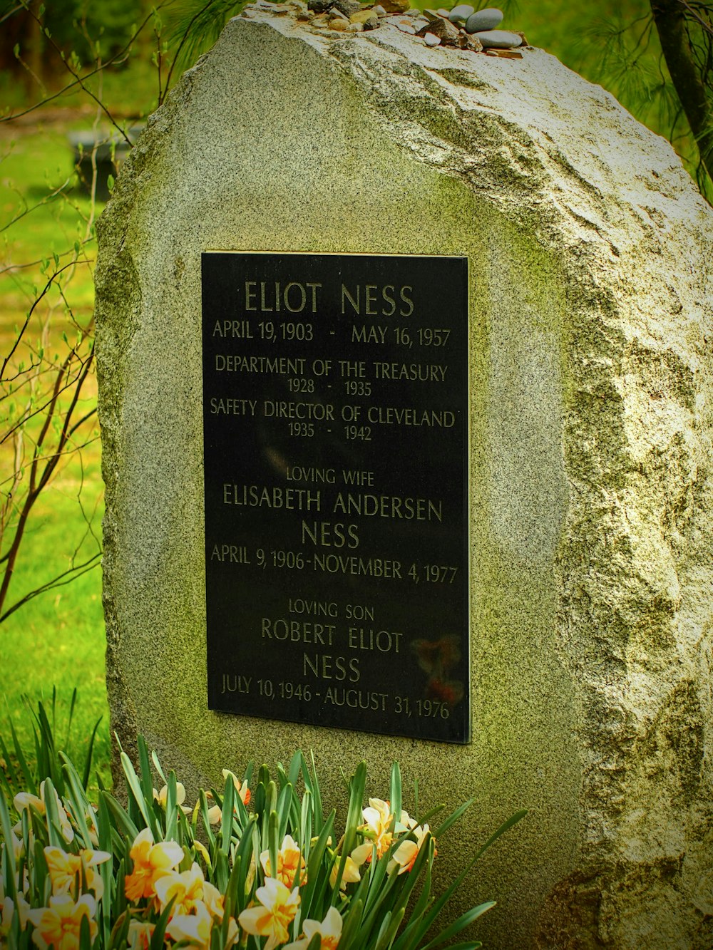 a memorial stone with a plaque on it