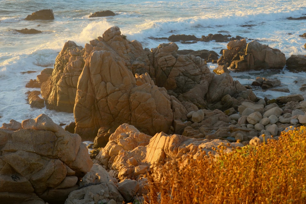 a rocky shore with waves crashing on the rocks
