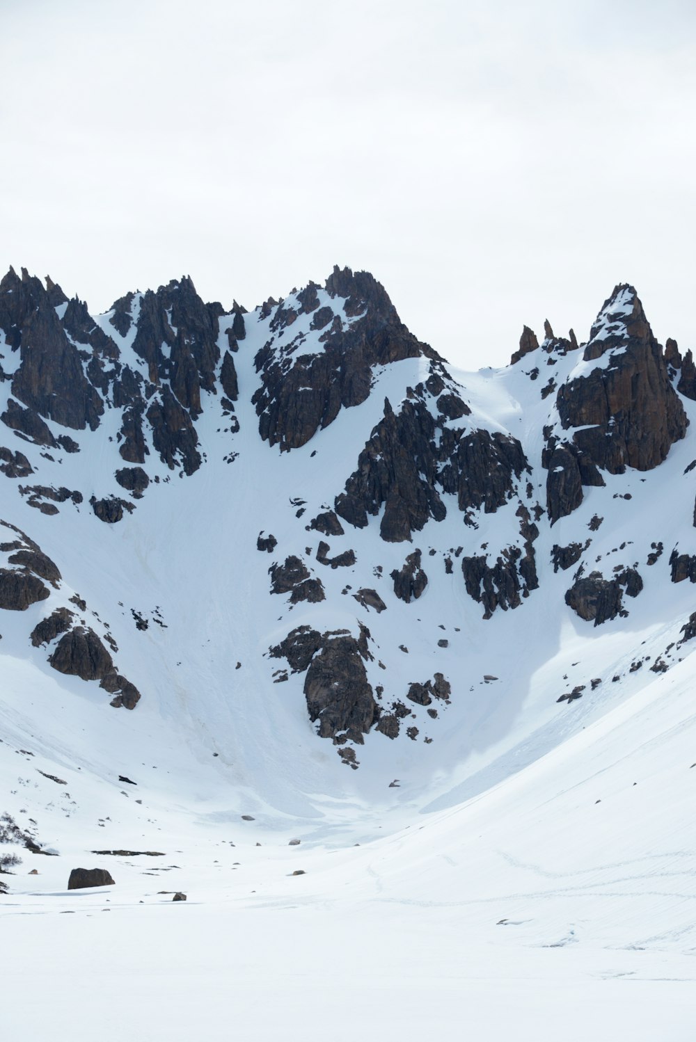 a man riding skis down a snow covered slope