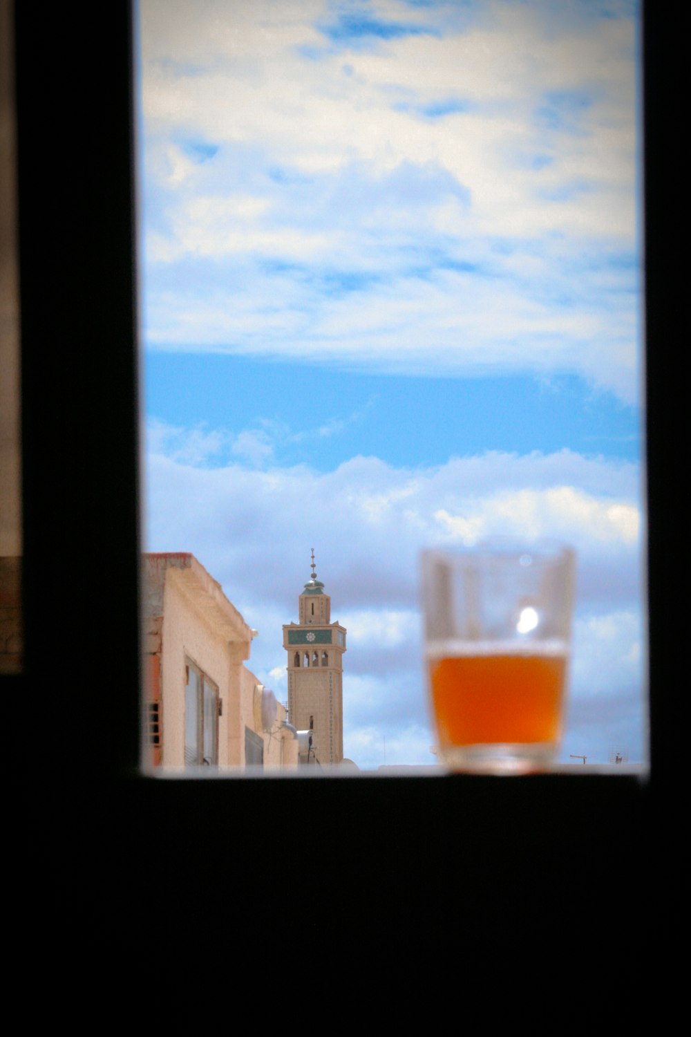 a view of a clock tower through a window