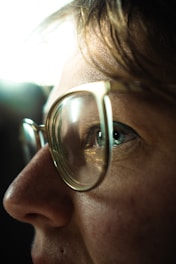 a close up of a person wearing glasses