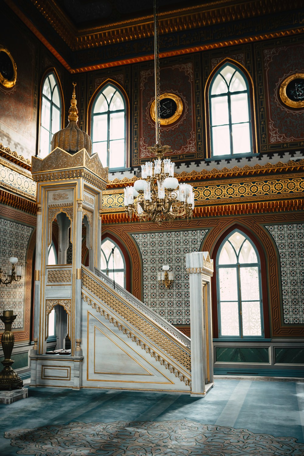 a staircase in a large building with a chandelier