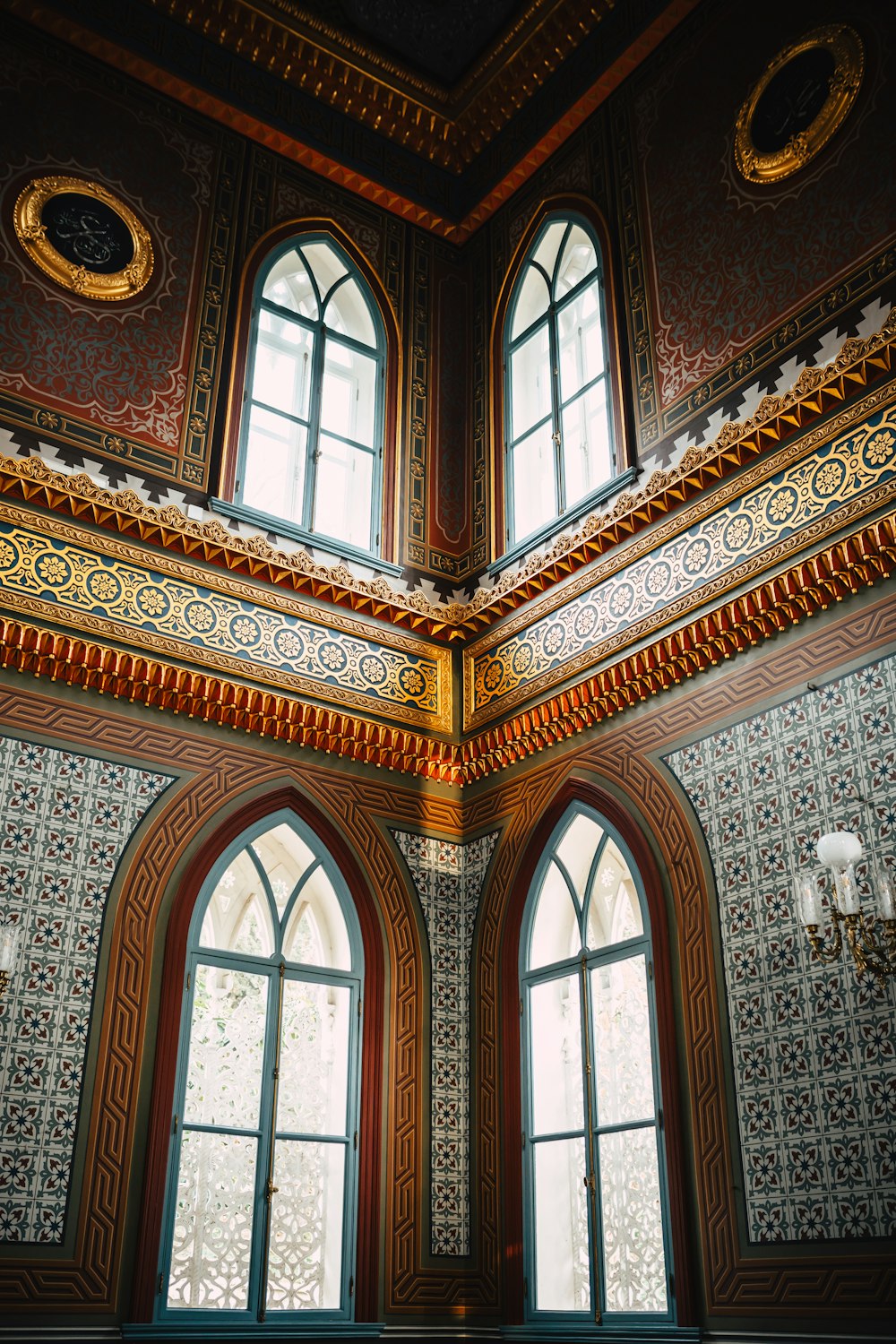 a room with two windows and a clock on the wall