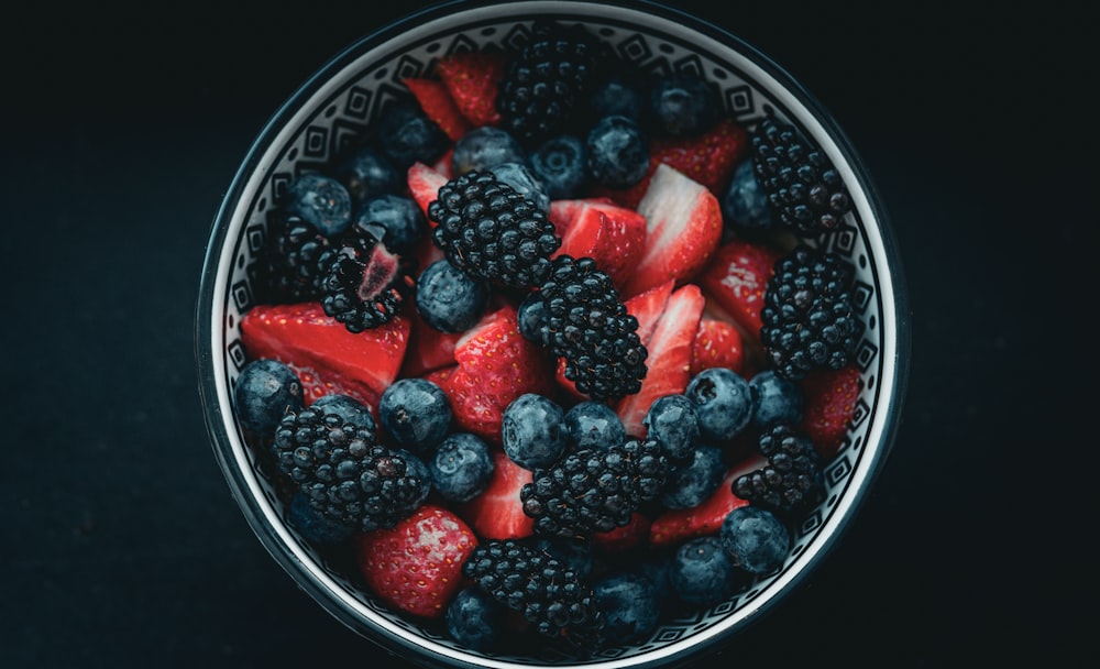 a bowl filled with berries and blueberries
