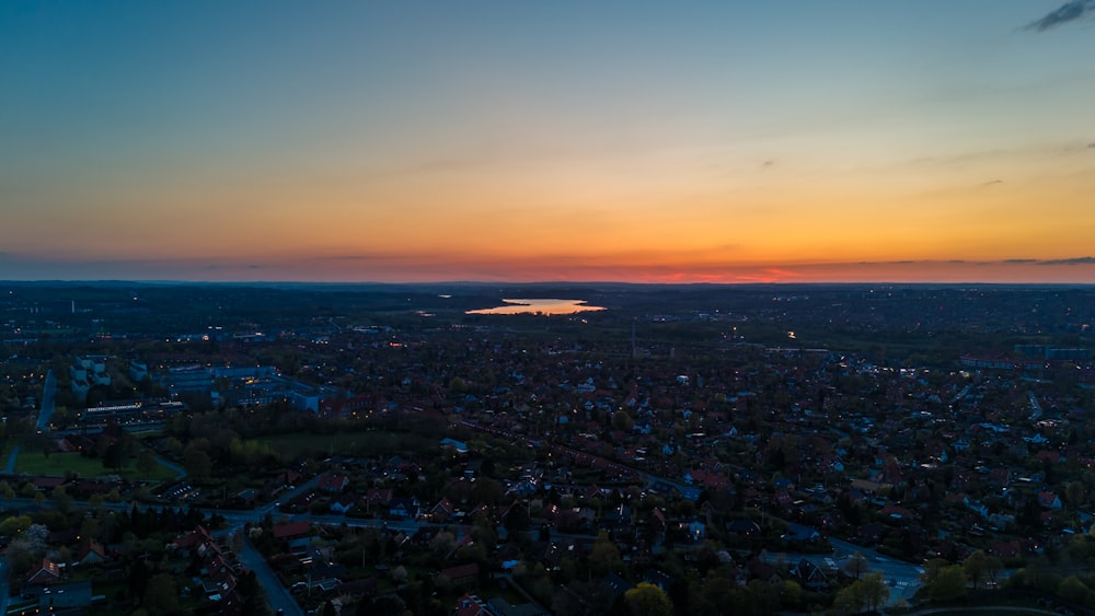 an aerial view of a city at sunset