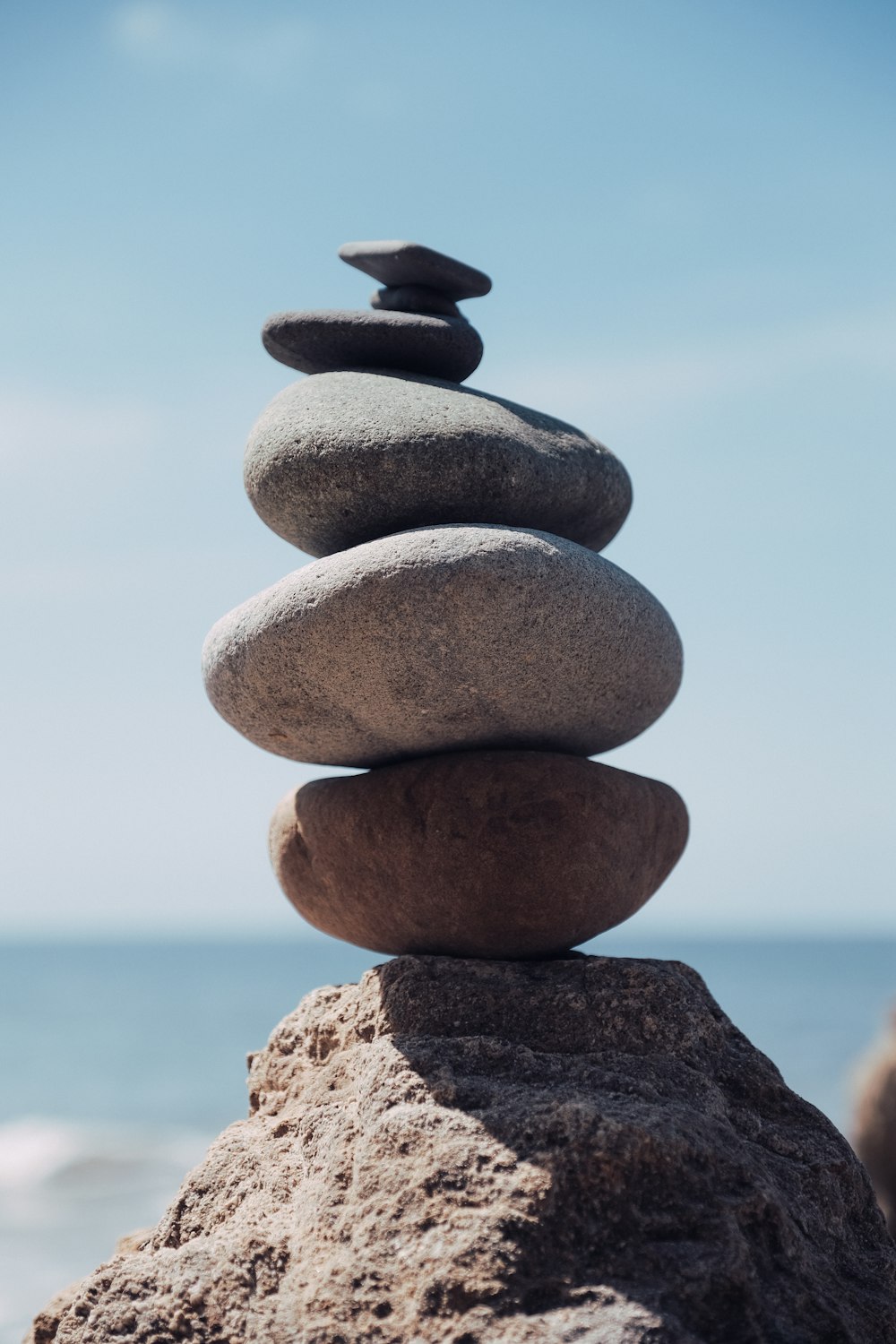 a stack of rocks sitting on top of a beach