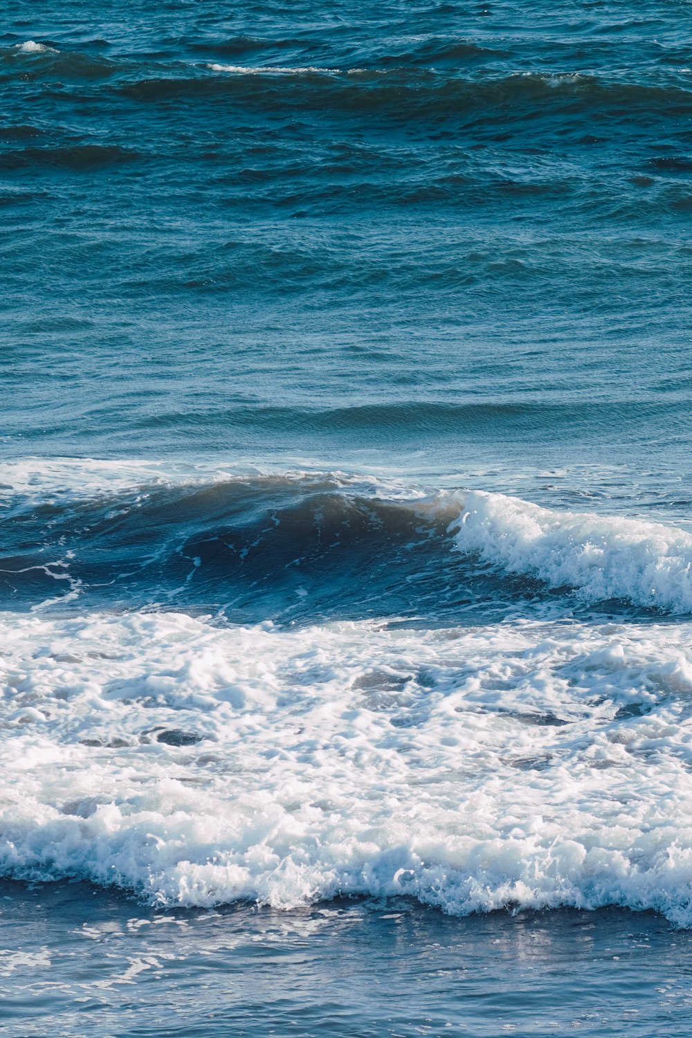 a man riding a wave on top of a surfboard