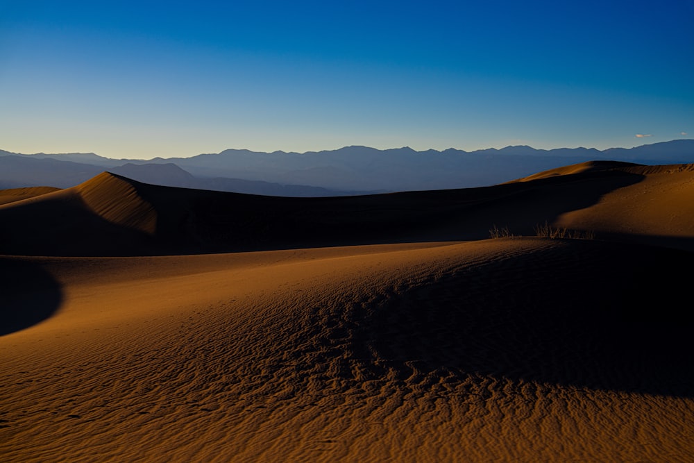 a desert landscape with mountains in the distance