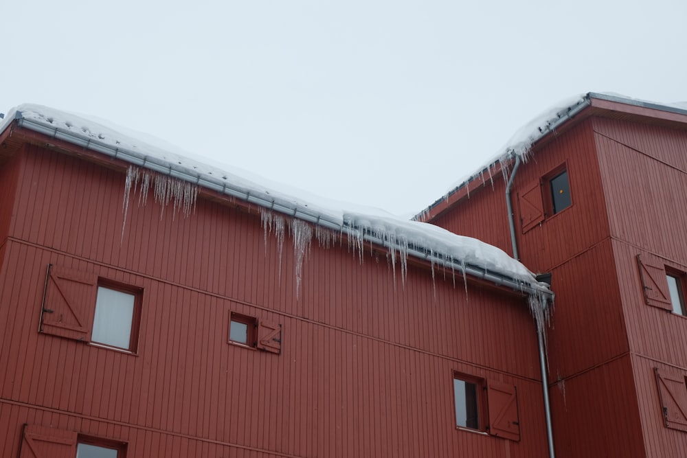 a red building with icicles on the roof