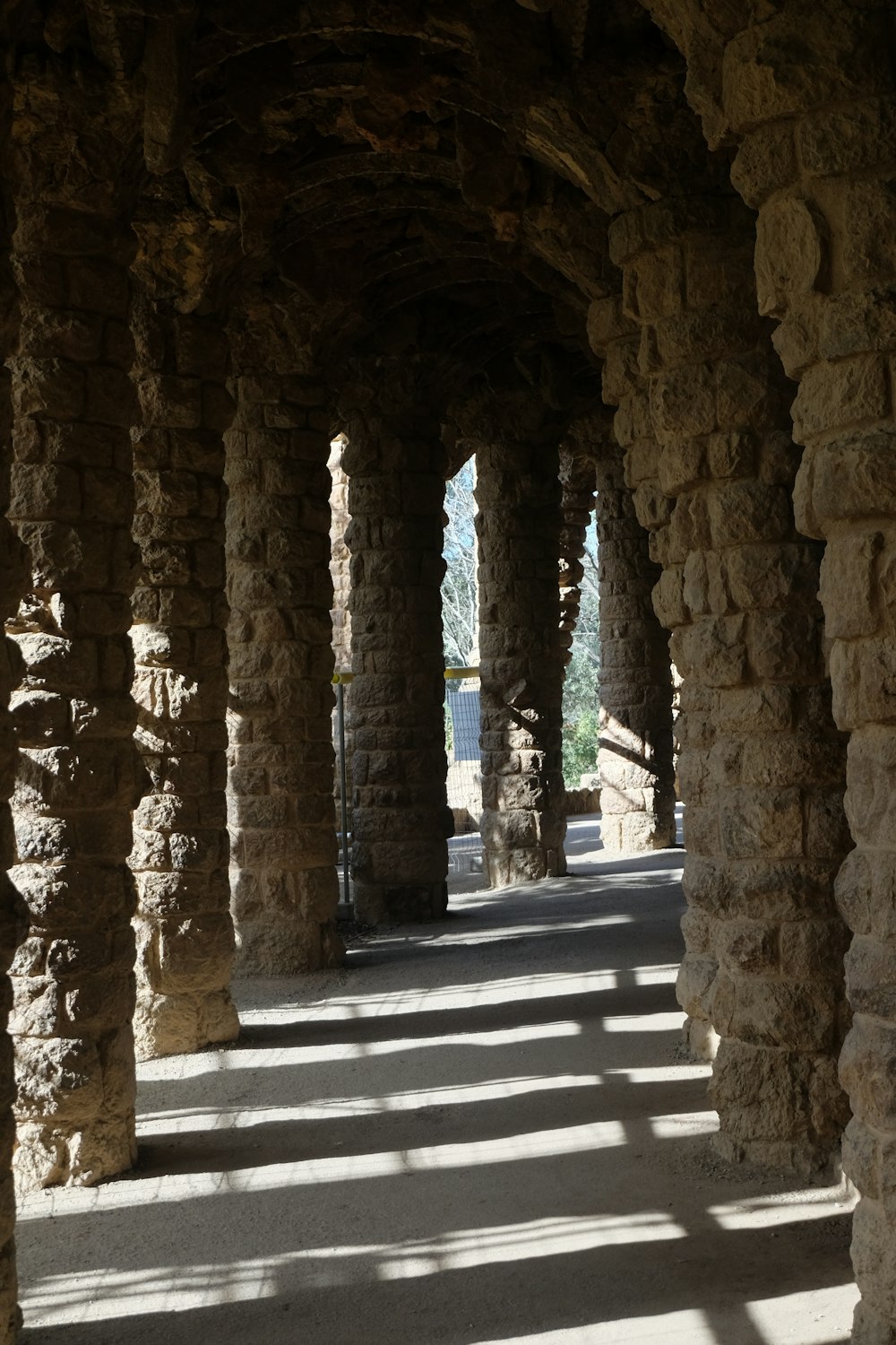 a row of stone pillars on a walkway