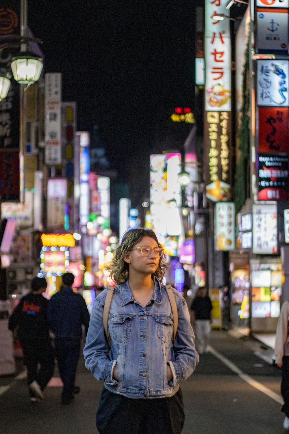 a man walking down a street at night