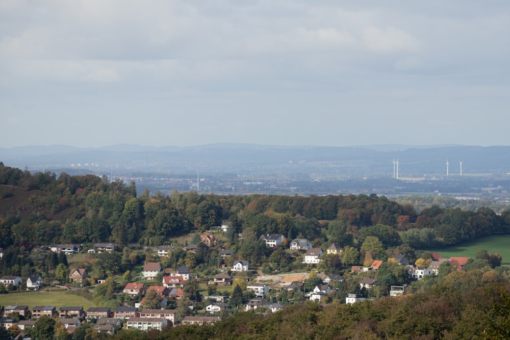 a view of a small town with mountains in the background