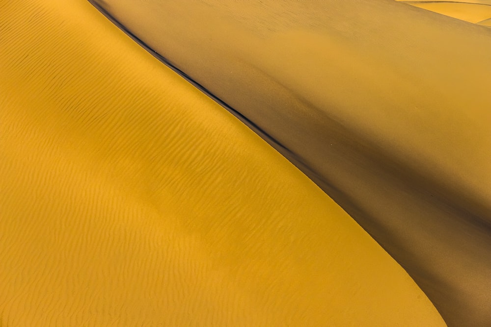 a desert landscape with a yellow sand dune