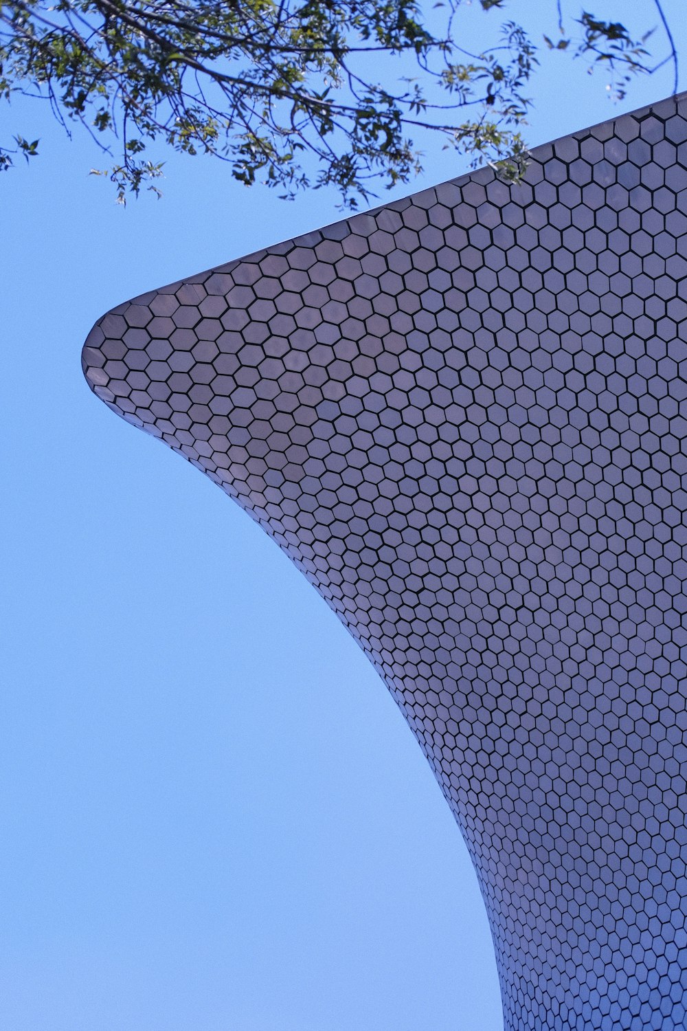 a plane flying in the sky over a building