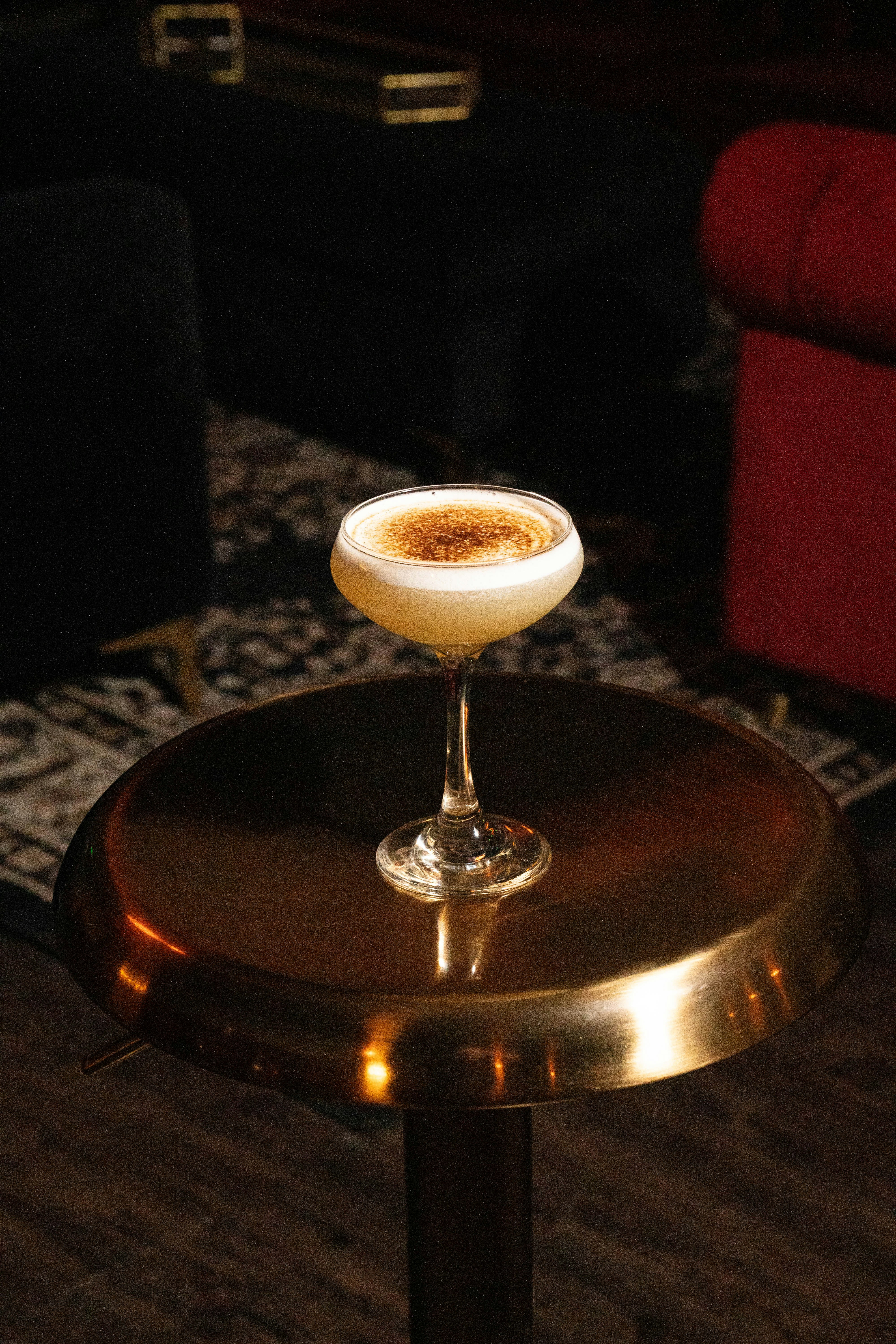 a drink sitting on top of a metal table