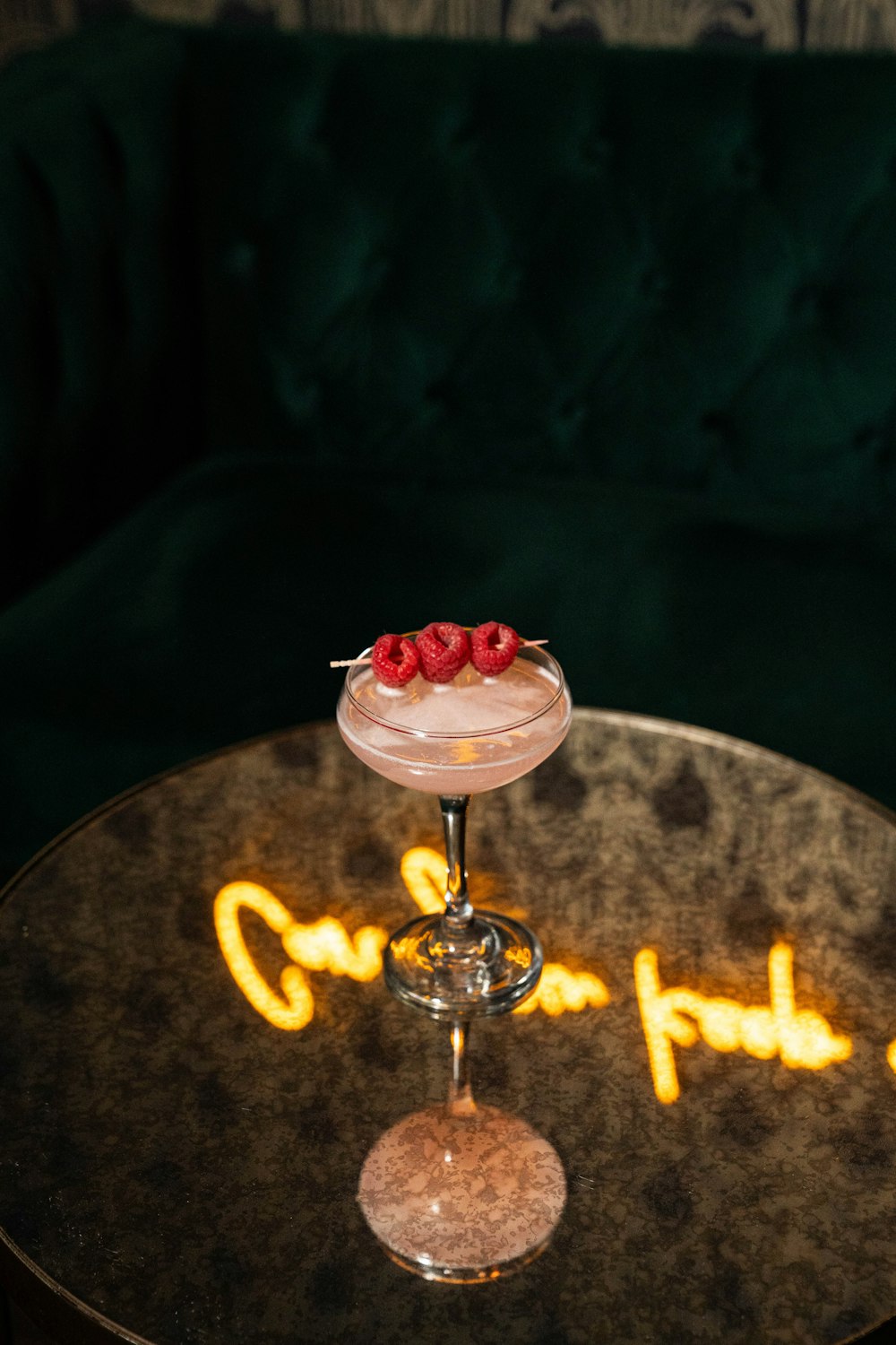 a cocktail sitting on top of a glass on top of a table