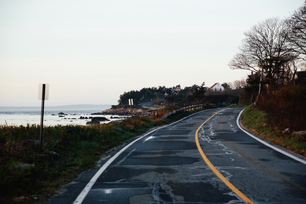 an empty road near a body of water
