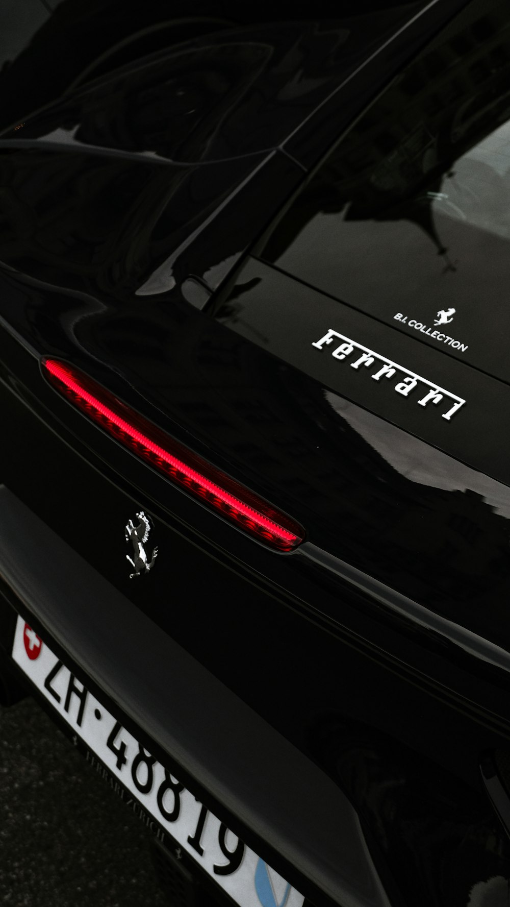a close up of the tail lights of a black sports car